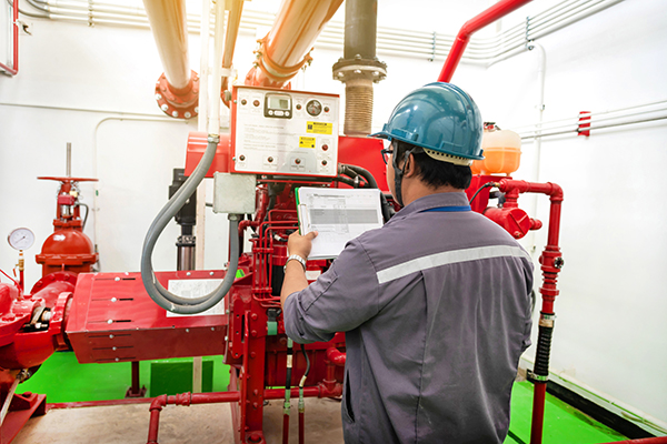 Engineer checking industrial generator fire control system